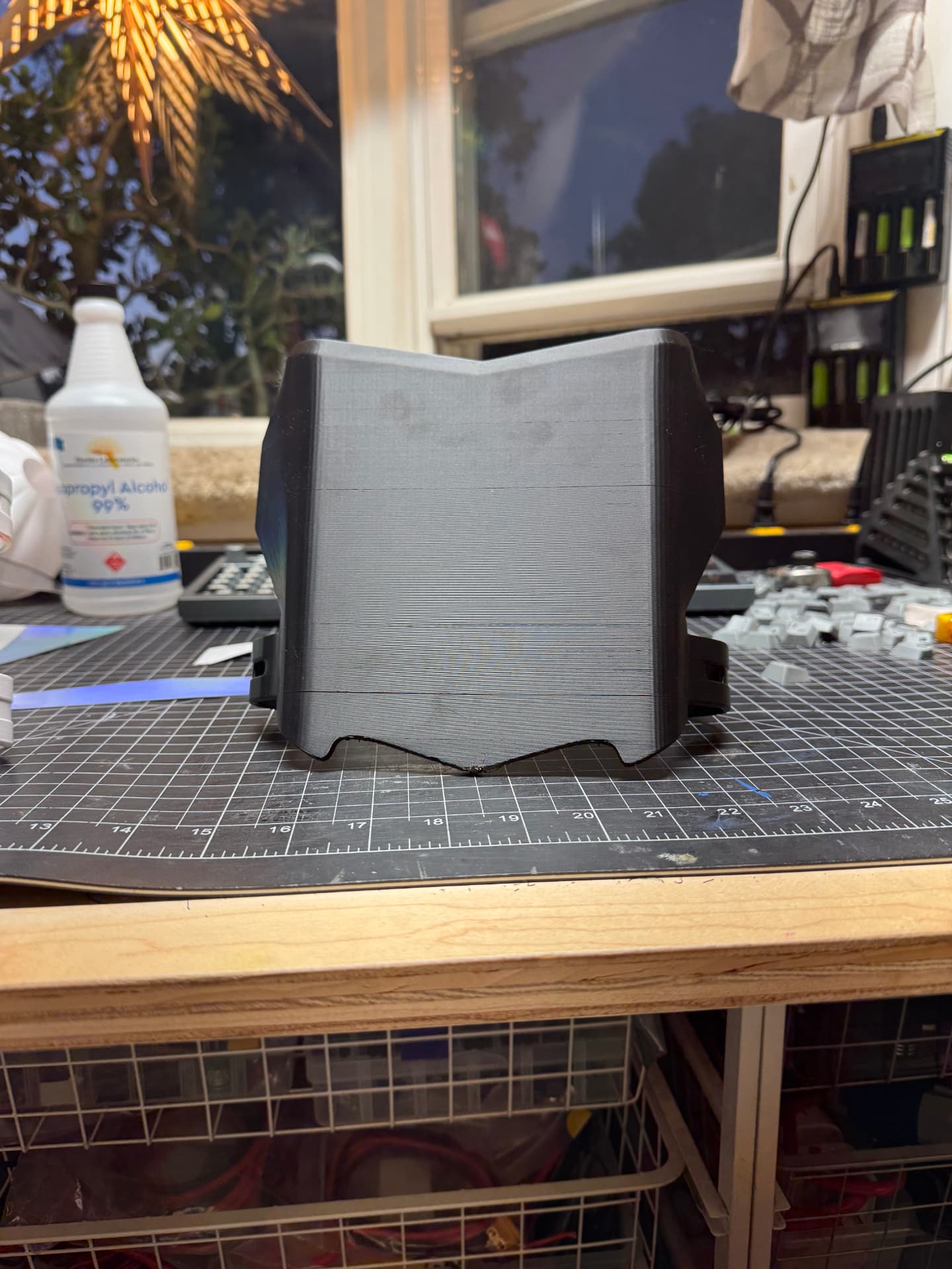 Black 3D printed front plate on a cutting mat